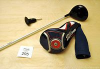 Photo of the Callaway Big Bertha Alpha driver with headcover and torque wrench on wooden surface.
