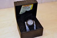 Watch on display cushion inside open Invicta Reserve box