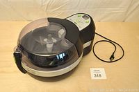 Full view of T-FAL ActiFry air fryer showing body, lid and power cord.
