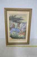 Frontal view of the framed watercolor painting showing its floral garden subject and overall condition.