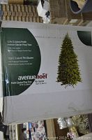 Box of the 12 ft Prelit Glacier Pine Tree showing brand and product details.