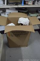 Cardboard box used for storage of items, labeled "Roland Drum System V-Compact series TD-11KV"