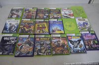 Full overhead view showing 15 Xbox 360 game cases laid out in rows, including Kinect titles and various genres