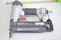 Porter Cable BN200SB brad nailer showing full tool with damaged black grip and silver metal components.