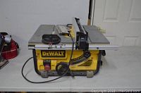 Front and side view of DeWalt DW745 table saw on table