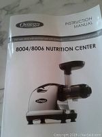 Instruction manual cover page titled 'Omega 8004/8006 Nutrition Center' showing picture of the juicer model and branding.