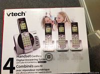Front of box showing four cordless handset phones and digital answering machine, 4 handset cordless digital answering system with caller ID/call waiting