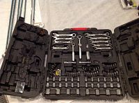 Photo of full open carrying case with all tools inside including wrenches, ratchets, sockets, bits and wire cutter tool.