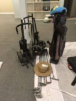 Golf set items including clubs, bag, dollies and hat arranged on floor