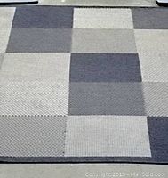 Close-up of the geometric pattern in blue and gray squares with varied textures.