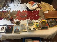 Photo showing DVDs, CDs, and various small items laid out on a table, including TV series and movie DVDs, woodworking instructional DVDs, and music CDs.