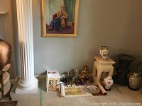 Front view of all items including painting, garden stool, teapot, vases, trinket box, figurines, scroll and magazines