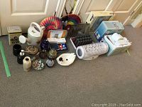 Photo showing whole lot with bathroom scale, Waterpik, toothbrush boxes, fans, decor items and hearing aid kit