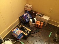 Grouping of two Intellivision consoles, Atari game boxes, Chatbot box, cassette recorder, tapes and dual deck