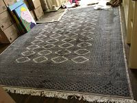 Full view of rug laid on floor showing overall pattern, size and color.