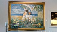 Full view of the large painting depicting two women in a garden near the beach with blue sky background, in a gold ornate frame.