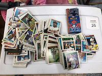 Wide view showing a large pile of assorted baseball cards including various teams and players.