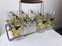 Set of six vintage cocktail glasses in metal carry tray with walnut wood handle on white towel background