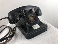 Front left side view showing handset, body, and worn cords.