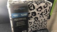 Packaged Cozy Spun double sheet set with leopard print visible through packaging