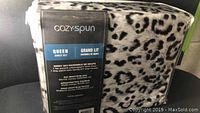 Photo of Cozy:Spun queen sheet set in original packaging showing animal print and product details