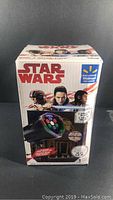 Image of the product box showing Star Wars branding and character artwork featuring the LED light projector.