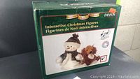 Box showing image and branding of interactive Christmas snowman and dog singing figures