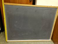 Two chalk boards with black writing surfaces and wooden frames. The boards measure 48x36 inches approximately.