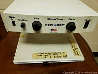 Front and top view of the Explorer MagniSight unit showing control knobs for black and white/sc reversal and counters, size, focus, and power switch.