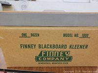 Cardboard box labeled 'One Dozen Finney Blackboard Kleener, Model No. 1800, Finney Company Minneapolis, Minnesota 55426'.