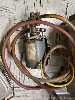Close-up of the electric pump showing the hoses and power cable attached.