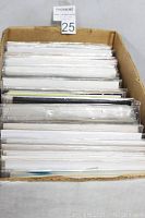 Photo showing box filled with comic books, mostly bagged in plastic with boards, tightly packed and standing upright.