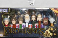 Front view of sealed original box displaying all seven Lord of the Rings character Pez dispensers with candy inside containers.