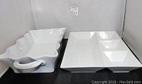 Front and side view of wavy-edged white porcelain bowl and rectangular compartmentalized platter side by side