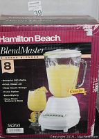 Front of box showing the Hamilton Beach BlendMaster blender with 8 speed settings, 350 watt motor, and 40 oz glass jar with wide mouth design.