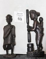 Pair of two handcrafted dark wood sculptures: mother with child and elder tribesman
