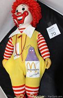 Full view of standing 22 inch Ronald McDonald doll showing detailed face, yarn hair, yellow jumpsuit with McDonald's insignia and Grimace in pocket