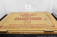 Cardboard box of The Pampered Chef Rectangular Baking Stone with branding and logo in red print.