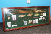 Full view of the fishing shadowbox showing all miniature items displayed on green felt background inside wooden case with glass cover.