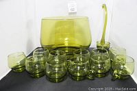 Whole vintage green glass punch bowl set arranged with bowl, server, and 11 cups showing size and color.
