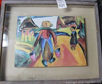 Front view of framed artwork showing elderly woman carrying water buckets on a path with a standing figure and houses in the background.