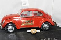 Right side view of red Volkswagen car decanter with Jim Beam label on the side and detached stopper in front.