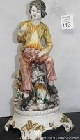 Front view of porcelain boy statue showing detailed colors and base