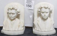 Front view of the pair of soapstone bust bookends showing detailed male figure carvings with formal attire.