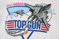 Close-up of the Top Gun graphic on the front of the white T-shirt showing fighter jets and Paramount's Great America logo.