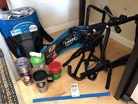 Photo showing bike rack, cooler backpack, Simply Fit Board, drinkware items on floor
