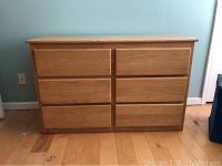 Front view of solid oak six drawer dresser showing front panel and drawer configuration.