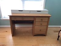 Oak desk with shelf and four drawers, three on right including hanging file drawer, and additional white storage unit with two drawers placed on top or separately