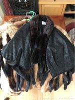 Black paisley jacquard stole draped over mink coats, showing overall layout