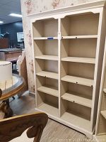 Front view of the white wooden bookcase showing two columns and multiple adjustable shelves.